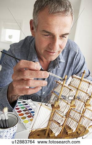 Mid age man model making View Large Photo Image Picture - Mid age man model making. Fotosearch