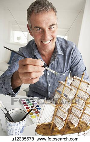 Mid age man model making View Large Photo Image Stock Photo - Mid age man model making. Fotosearch