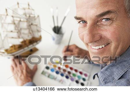 Stock Photograph - Mid age man model making. Fotosearch