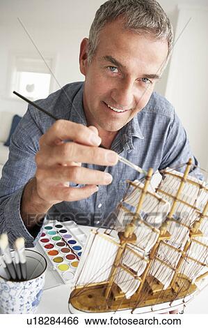 Mid age man model making View Large Photo Image Stock Photograph - Mid age man model making. Fotosearch