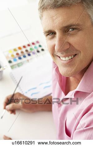 Mid age man painting with watercolors View Large Photo Image Stock Image - Mid age man painting with watercolors. Fotosearch