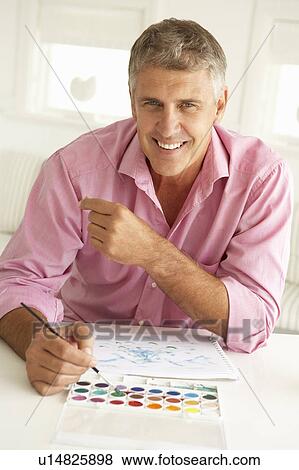 Mid age man painting with watercolors View Large Photo Image Stock Photo - Mid age man painting with watercolors. Fotosearch