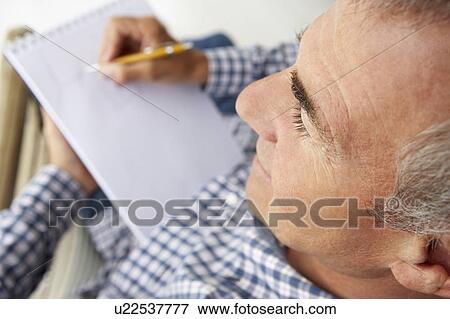 Mid age man sketching View Large Photo Image Stock Photo - Mid age man sketching. Fotosearch