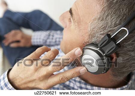 Mid age man wearing headphones View Large Photo Image Stock Image - Mid age man wearing headphones. Fotosearch