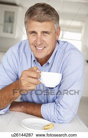 Mid age man with coffee at home View Large Photo Image Stock Photo - Mid age man with coffee at home. Fotosearch