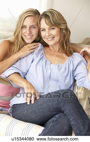 Mid age woman and teenage daughter at home View Large Photo Image Stock Image - Mid age woman and teenage daughter at home. Fotosearch