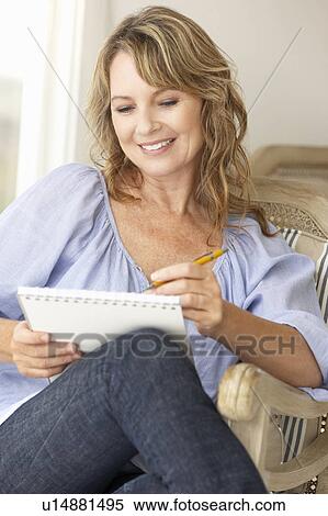 Stock Photography - Mid age woman sketching. Fotosearch