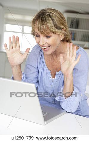 Mid age woman using laptop View Large Photo Image Stock Photo - Mid age woman using laptop. Fotosearch