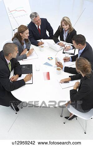 Stock Image - Mixed group in business meeting. Fotosearch