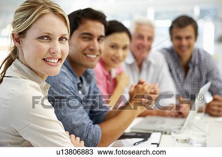 Stock Image - Mixed group in business meeting. Fotosearch