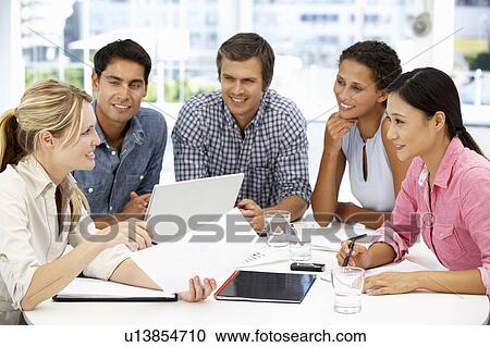 Stock Image - Mixed group in business meeting. Fotosearch