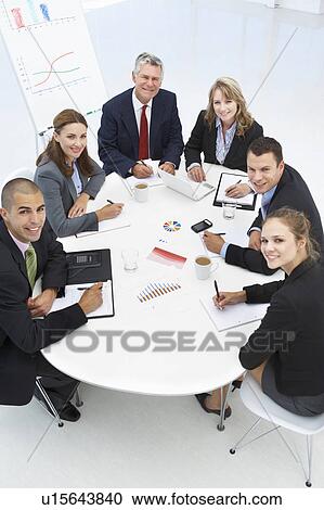 Stock Image - Mixed group in business meeting. Fotosearch