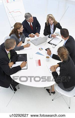 Stock Photo - Mixed group in business meeting. Fotosearch