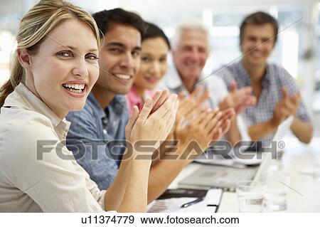 Stock Photo - Mixed group in business meeting. Fotosearch