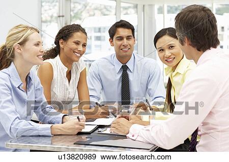 Stock Photo - Mixed group in business meeting. Fotosearch