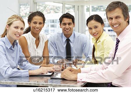 Stock Photo - Mixed group in business meeting. Fotosearch