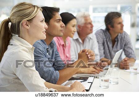 Stock Photo - Mixed group in business meeting. Fotosearch