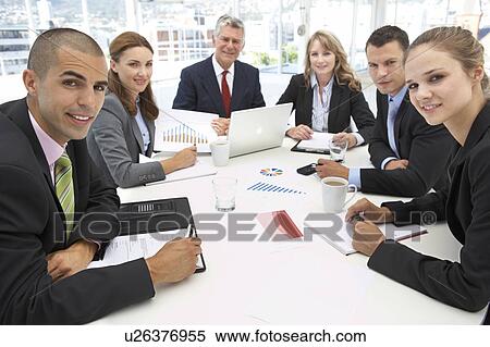 Stock Photography - Mixed group in business meeting. Fotosearch