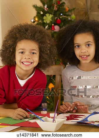 Mixed race children making Christmas cards View Large Photo Image Stock Image - Mixed race children making Christmas cards. Fotosearch
