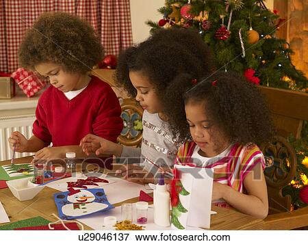 Mixed race children making Christmas cards View Large Photo Image Stock Photo - Mixed race children making Christmas cards. Fotosearch