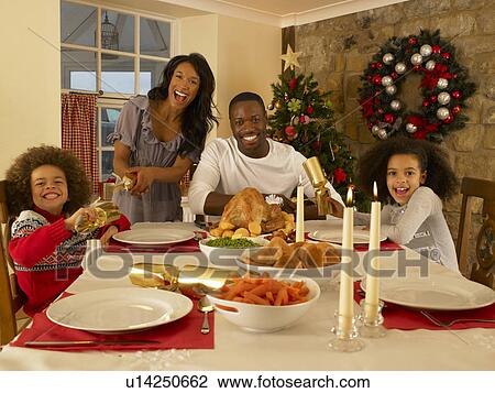 Mixed race family having Christmas dinner View Large Photo Image Stock Image - Mixed race family having Christmas dinner. Fotosearch