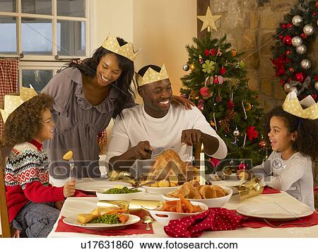Mixed race family having Christmas dinner View Large Photo Image Stock Image - Mixed race family having Christmas dinner. Fotosearch