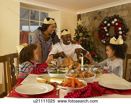 Mixed race family having Christmas dinner View Large Photo Image Stock Photography - Mixed race family having Christmas dinner. Fotosearch