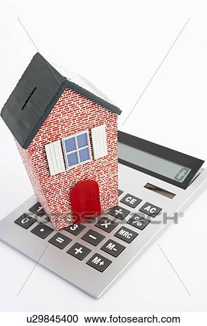 Stock Image - Model house and calculator. Fotosearch