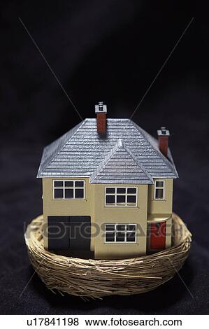 Stock Photo - Model house in a basket. Fotosearch