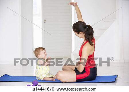 Mother and baby doing yoga View Large Photo Image Stock Image - Mother and baby doing yoga. Fotosearch