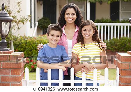 Stock Photograph - Mother and children outside home. Fotosearch