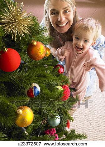 Stock Photo - Mother and daughter with Christmas tree. Fotosearch