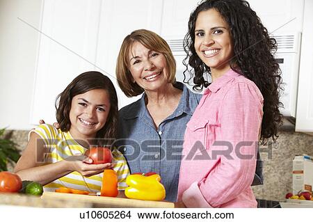 Picture - Mother, daughter and grandmother cooking. Fotosearch