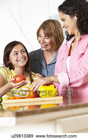 Stock Photo - Mother, daughter and grandmother cooking. Fotosearch
