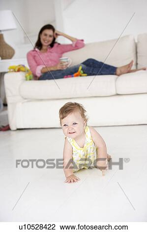 Mother watching baby crawl View Large Photo Image Stock Image - Mother watching baby crawl. Fotosearch