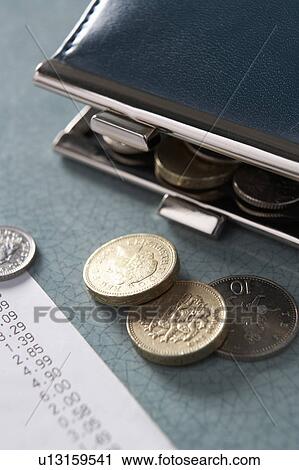 Stock Image - Open purse with till receipt and coins. Fotosearch