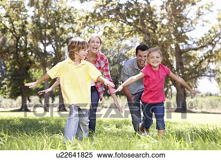 Parents playing with children in country View Large Photo Image Stock Photography - Parents playing with children in country. Fotosearch
