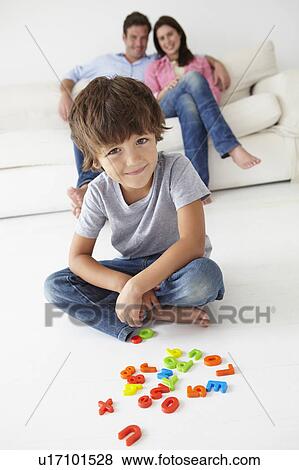 Parents watching son play View Large Photo Image Stock Photo - Parents watching son play. Fotosearch