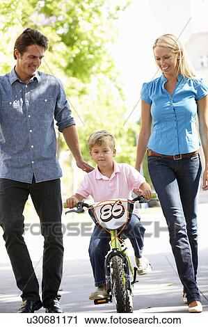Parents with boy on bike View Large Photo Image Stock Image - Parents with boy on bike. Fotosearch