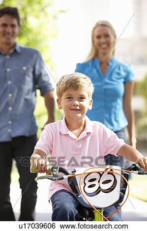 Parents with boy on bike View Large Photo Image Stock Photograph - Parents with boy on bike. Fotosearch