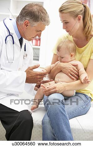 Stock Image - Pediatrician with baby. Fotosearch