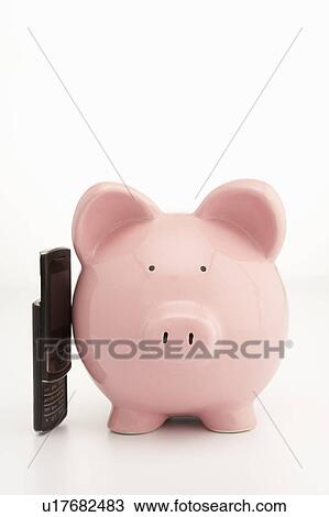 Stock Image - Piggybank and cellphone. Fotosearch