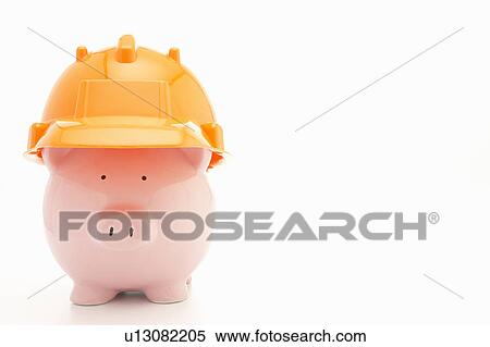 Stock Photography - Piggybank with hard hat. Fotosearch