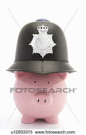 Stock Photography - Piggybank with policeman's helmet. Fotosearch