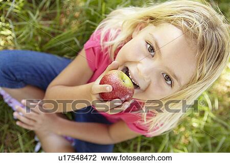 Portrait of happy girl with apple View Large Photo Image Stock Image - Portrait of happy girl with apple. Fotosearch