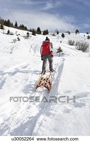 Pre-teen Boy Pulling A Sled In The Snow View Large Photo Image Picture - Pre-teen Boy Pulling A Sled In The Snow. Fotosearch