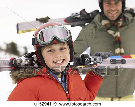 Stock Photo - Pre-teen Boy With Father On Ski Vacation. Fotosearch