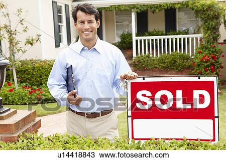Stock Image - Real estate agent at work. Fotosearch