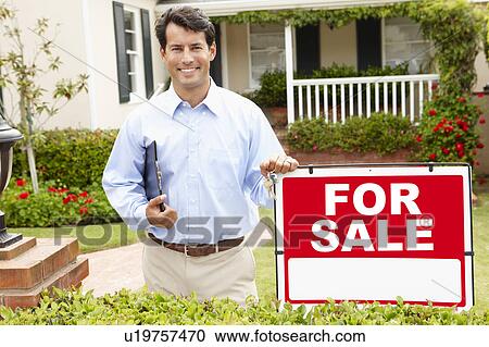 Stock Image - Real estate agent at work. Fotosearch