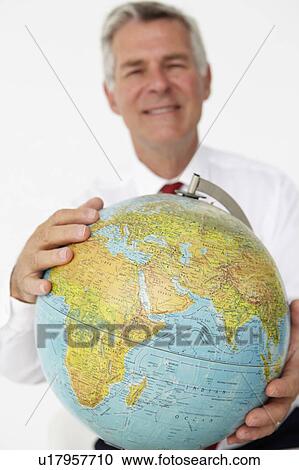 Senior businessman holding globe View Large Photo Image Stock Image - Senior businessman holding globe. Fotosearch